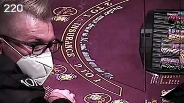 A photo from the Justice Department allegedly showing Andrew Marnell at a Black Jack table