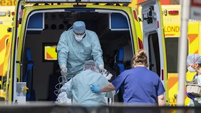 A patient being taken into an ambulance