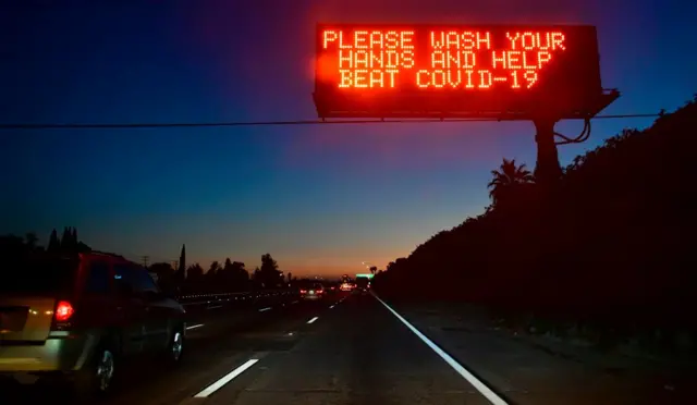 A sign on a Los Angeles freeway reminds people to wash their hands to help beat Covid-19