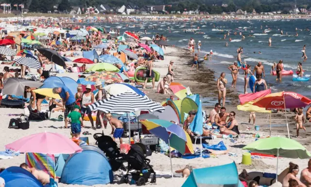 Bathers crowd on a beach on July 27, 2018 on the Baltic Sea in Scharbeutz