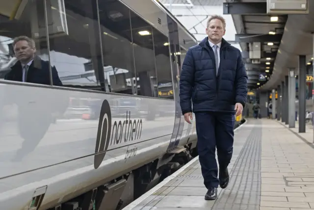 Grant Shapps next to a train