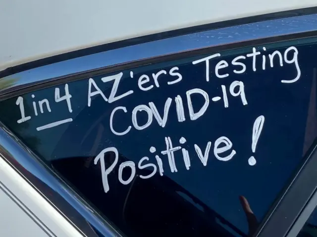 A sign reads '1 in 4 Arizonans testing Covid-19 positive!'