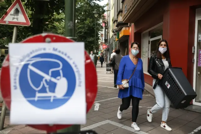 People wear masks while walking around Brussels