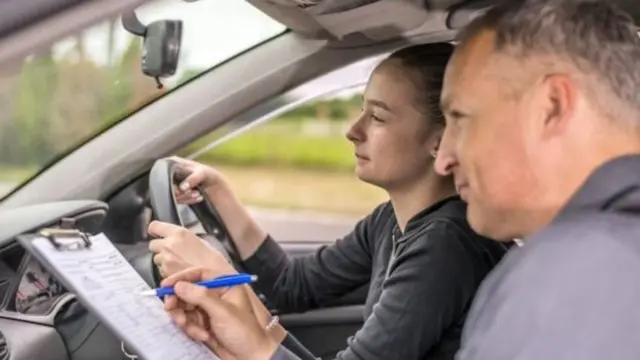 A woman sitting a driving test