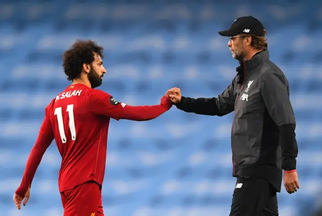 Mohamed Salah of Liverpool interacts with Jurgen Klopp, Manager of Liverpool