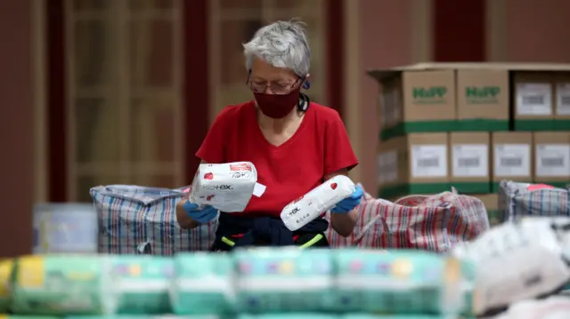 Volunteer working on food parcels