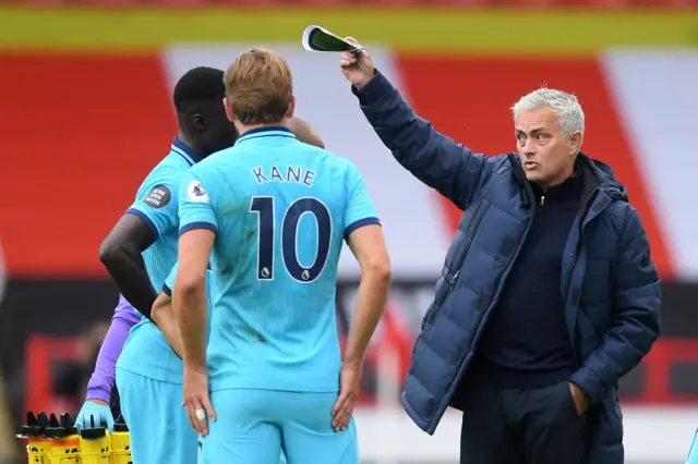 Tottenham manager Jose Mourinho gestures to his players during a drinks break