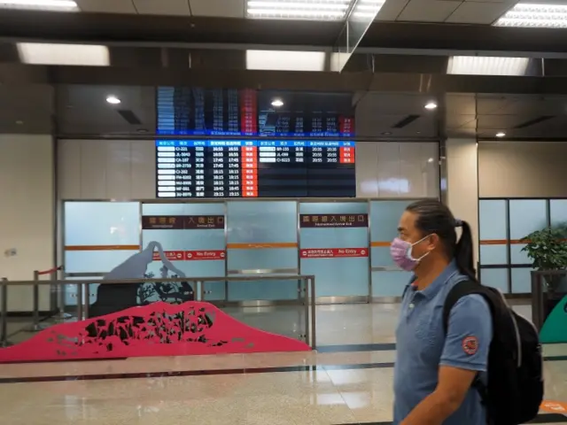 A man walks past international arrivals at Taiwan's Taipei Songshan Airport