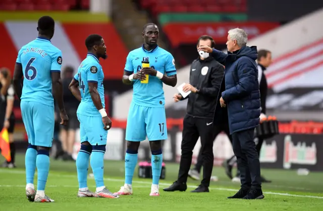 Tottenham Hotspur manager Jose Mourinho speaks to Serge Aurier and Moussa Sissok