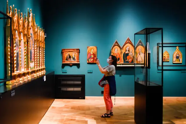 A visitor takes a photo in the Palace of the Princess Czartoryski Museum in Poland