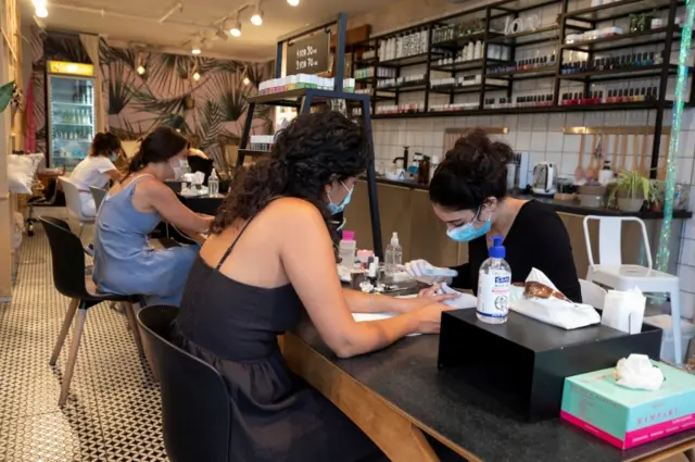 Customers visit a nail salon