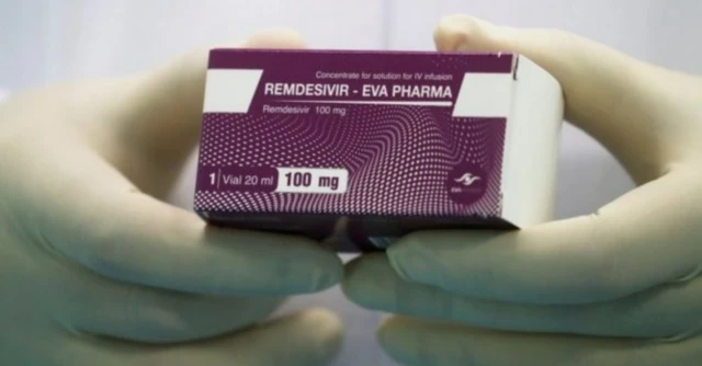 A health worker holding a box of remdesivir drug