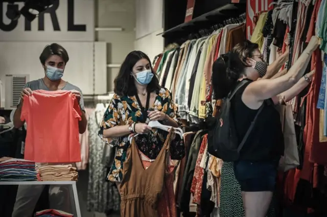 Clients wearing protective face masks in a shop in Bordeaux, France, on 19 July 2020