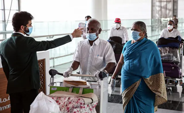 Indian nationals have their body temperatures measured in Muscat International Airport