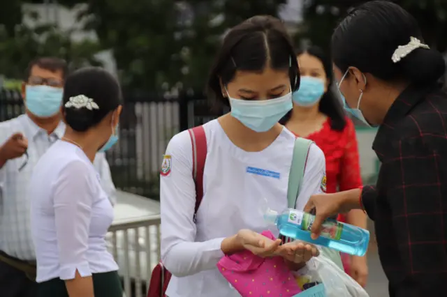 Student using hand sanitiser