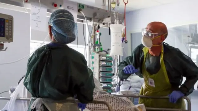 Doctors wearing PPE in a hospital