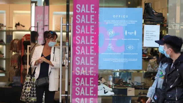 Woman wearing mask in shop