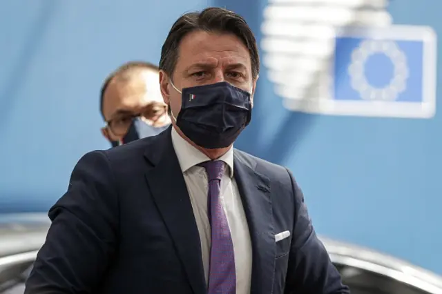 Giuseppe Conte, wearing a protective face mask, arrives for the fourth day of an EU summit