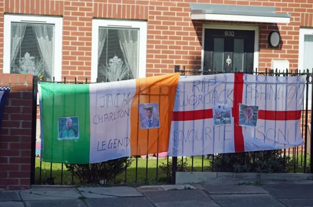 Irish and England flags on fence