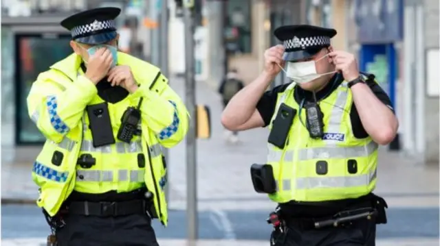 Policemen wearing masks