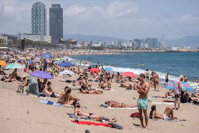 People are seen sunbathing at a Barcelona beach during the coronavirus crisis