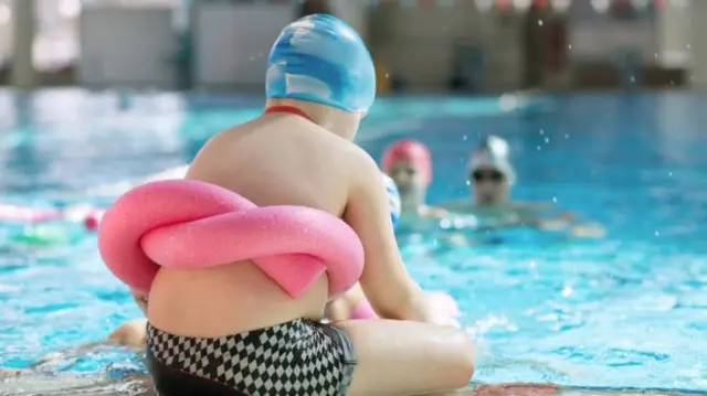 Boy beside pool