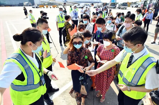 Passengers line up to board a China-made regional jetliner ARJ21 operated by China Southern Airlines at Guangzhou Baiyun International Airport in Guangzhou