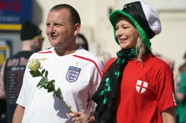 Two people in England shirts