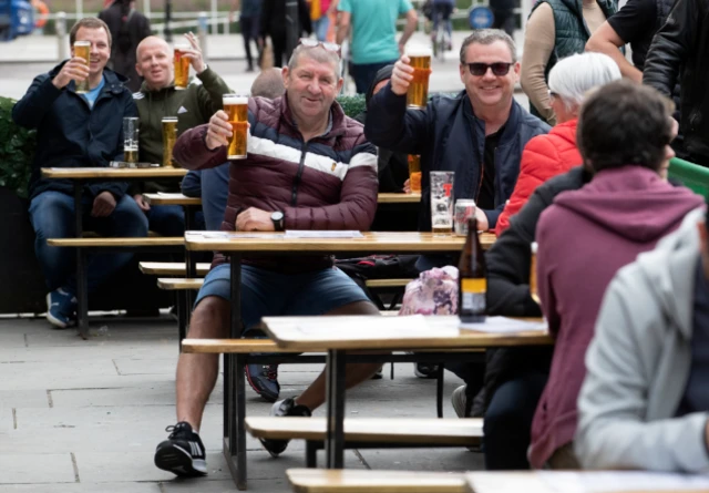 Members of the public enjoy their first drink in a beer garden at the Hootenanny, Glasgow, as outdoor areas reopen to the public for the first time as Scotland continues with the gradual lifting of restrictions to ease out of lockdown.