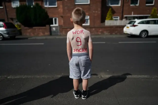 Lad with back tribute