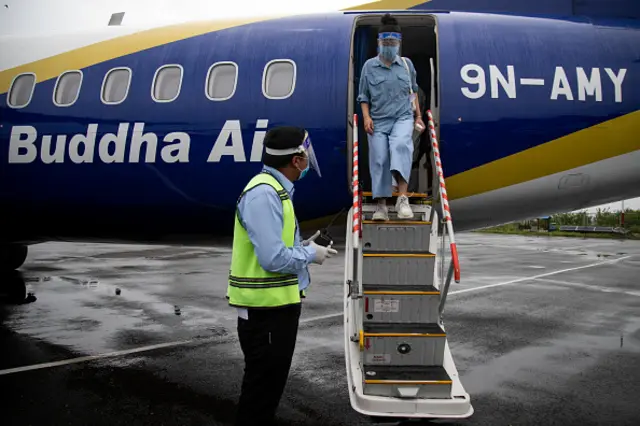 An airline staff wearing a face shield at Trivbhuvan international airport during a safety drill