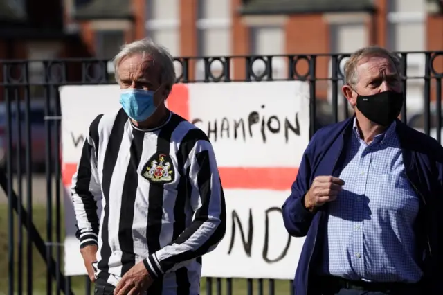 men in masks at cortege