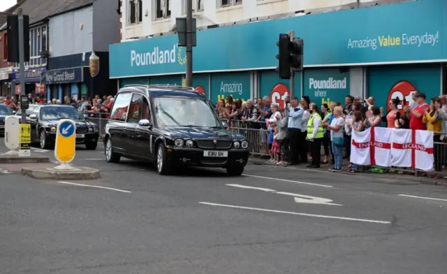 Hearse outside Poundland crowd