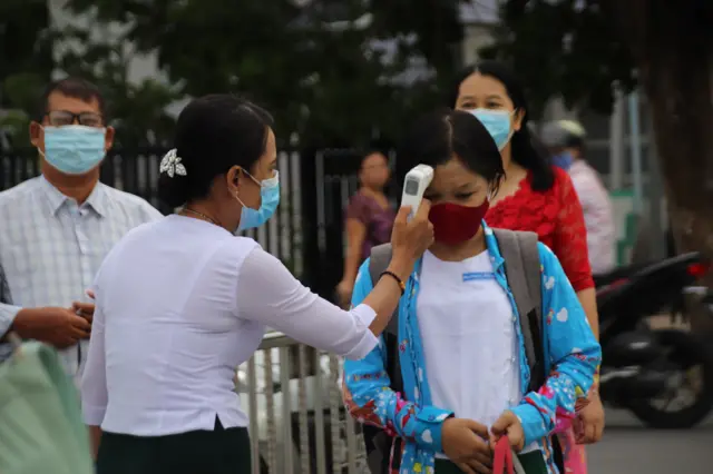 Students having temperature checks