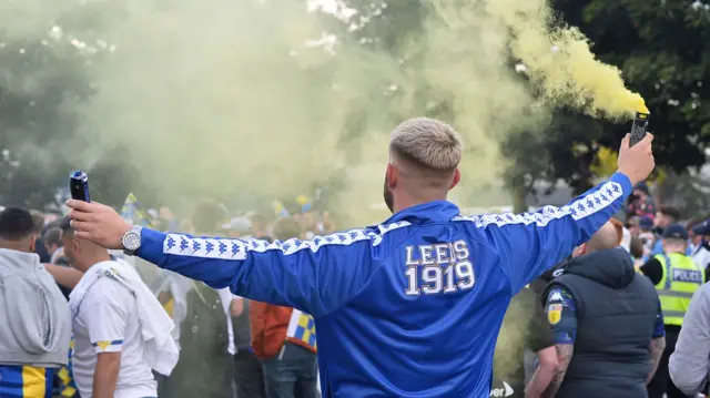 A Leeds fan with a smoke bomb