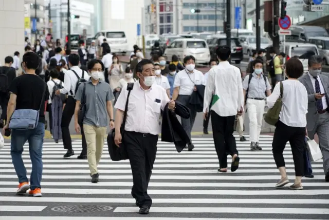 Pedestrians wear masks in Tokyo