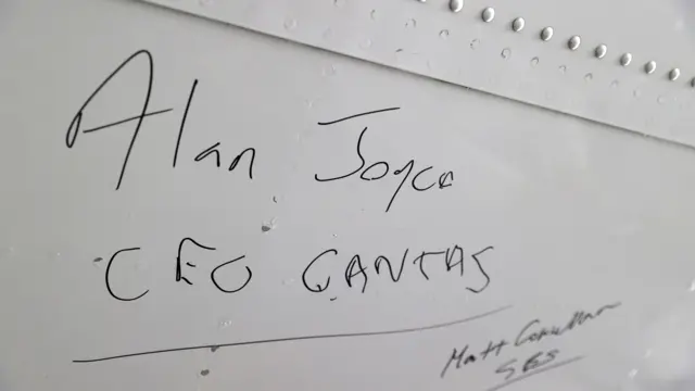 Alan Joyce's signature is seen at the bottom of a Qantas 747 jumbo jet