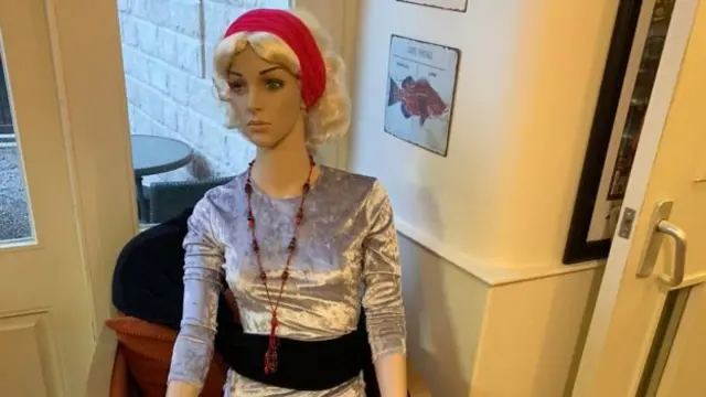 A smartly dressed mannequin at La Brasserie De La Cour restaurant