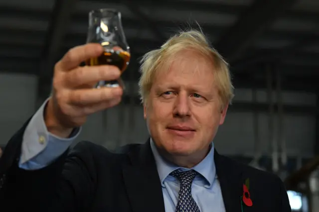 Boris Johnson with a glass of whisky