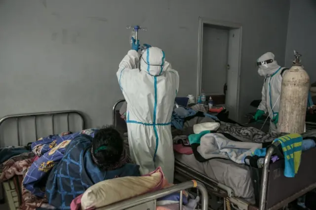 A patient is treated by health workers in Antananarivo