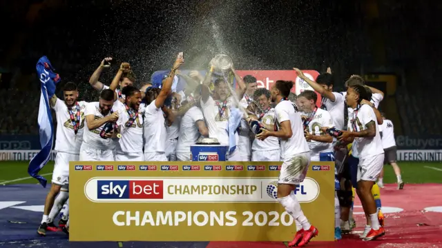 Leeds players lift the trophy