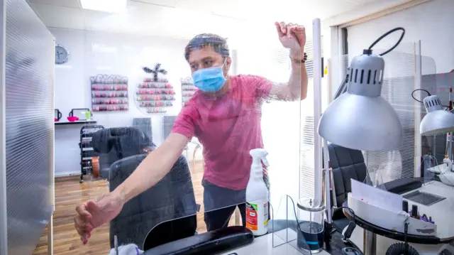 Bau Van Pham, manager of Nails and Spa on Croall Place, Edinburgh, cleans and makes preparations before the salon reopens on Wednesday July 22 as Scotland prepares for the lifting of further coronavirus lockdown restrictions.