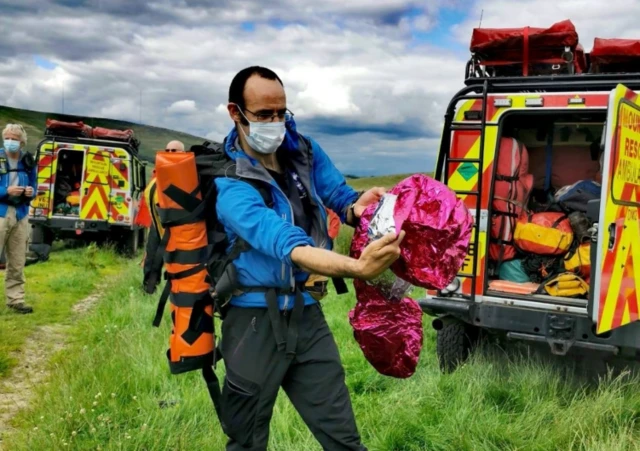 Mountain rescuer with pink balloon