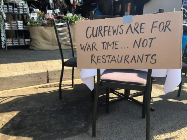 Empty restaurant table with sign