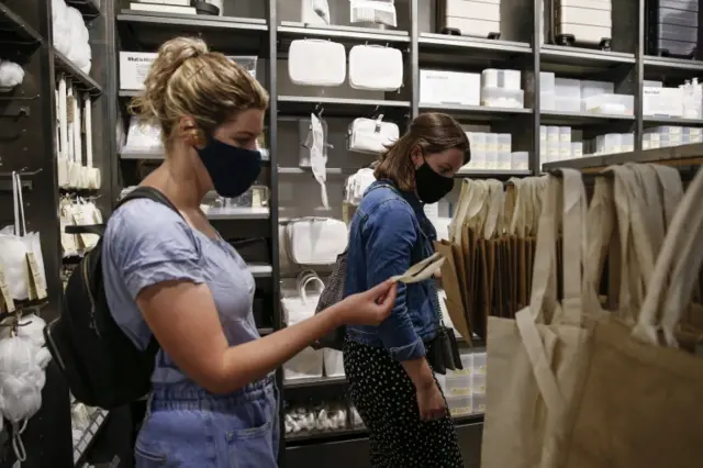 Two shoppers in face coverings
