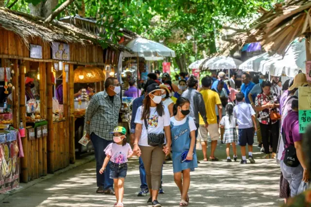 Local tourists visit a market north of Bangkok