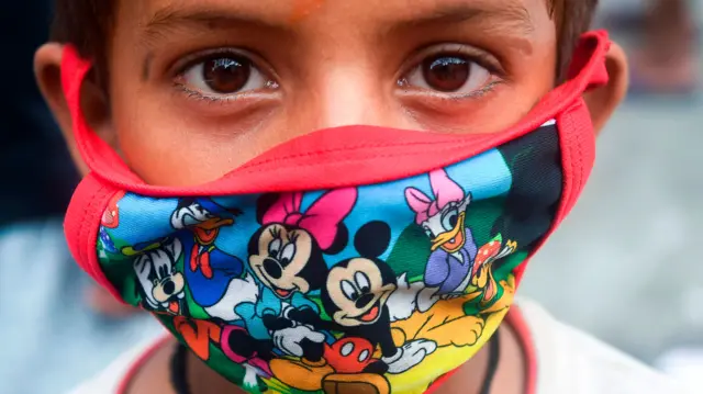 Boy wearing mask with Disney characters on it in India