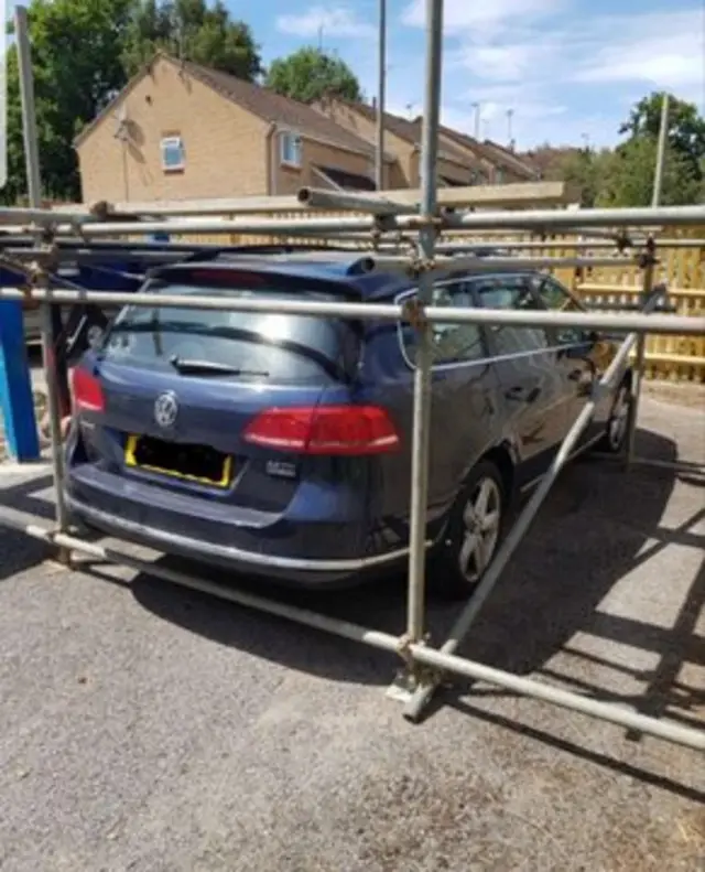 Car encased in scaffolding