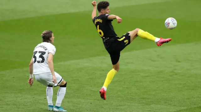 Christian Noergaard of Brentford stretches for the ball under pressure from Conor Gallagher of Swansea City