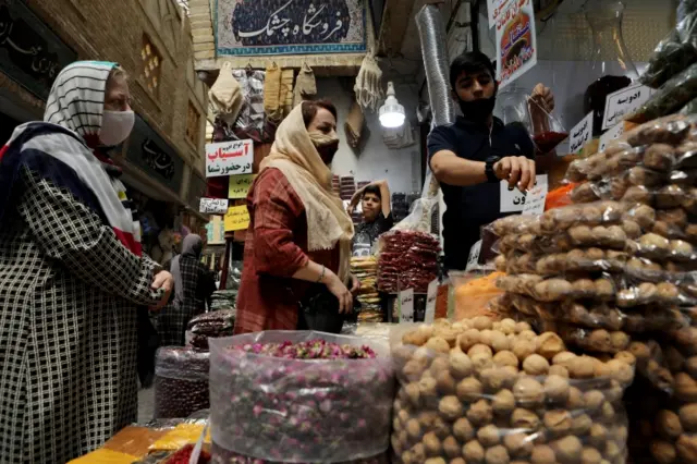 Women wearing protective face masks shop at a bazaar following the outbreak of coronavirus, in Tehran, Iran, July 8, 2020